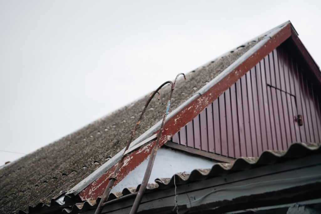 Wind damaged shingles on residential roof after storm